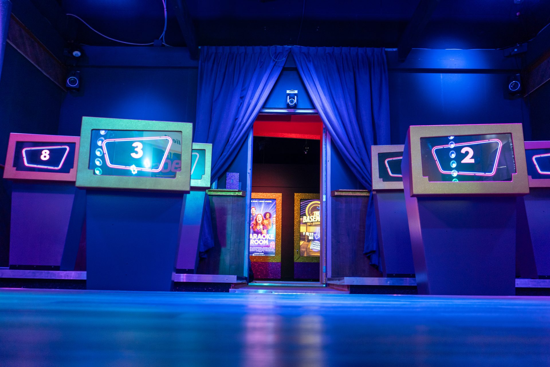 QuizX Arena with illuminated desks and large quiz screen