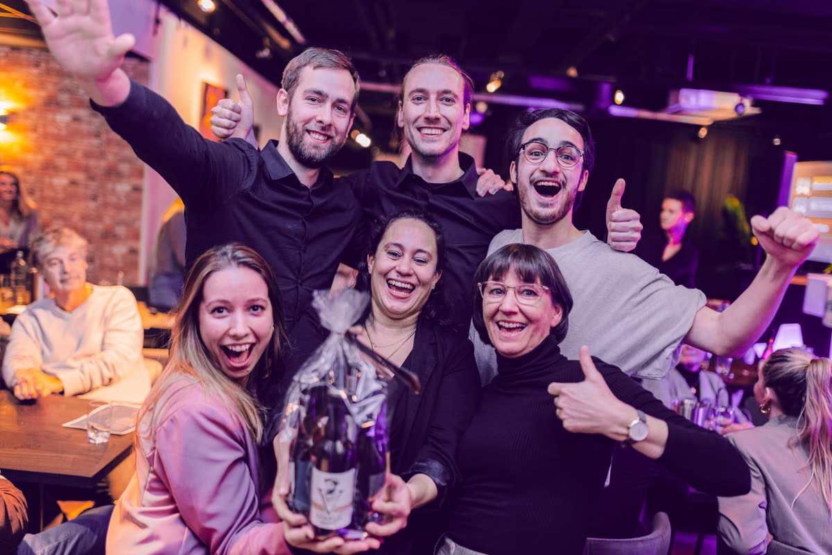 Winning team celebrating at a QuizX dinner show