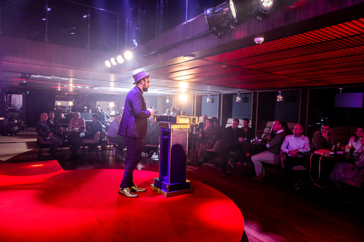 Quiz show host on stage in the spotlight
